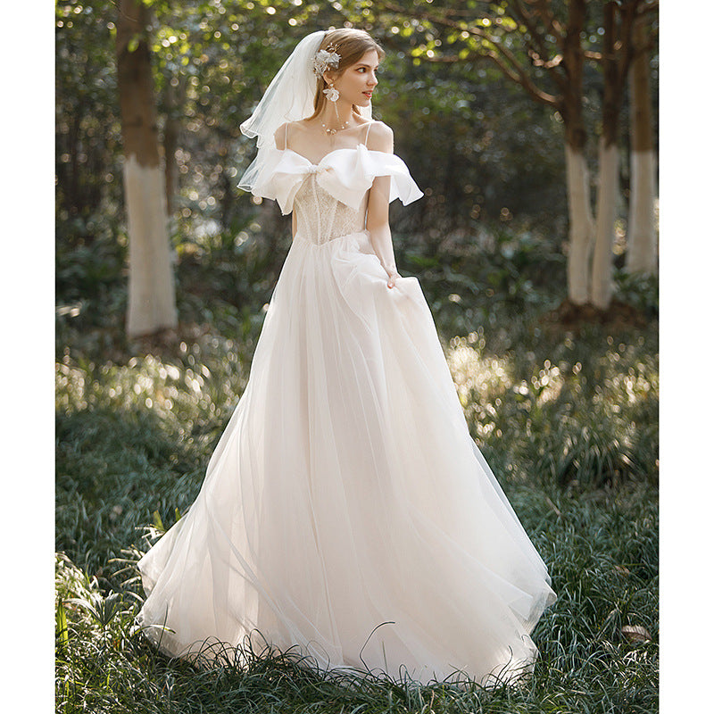 light wedding dress 2025 new bride one-word shoulder suspenders small bow temperament presiding over dress trailing