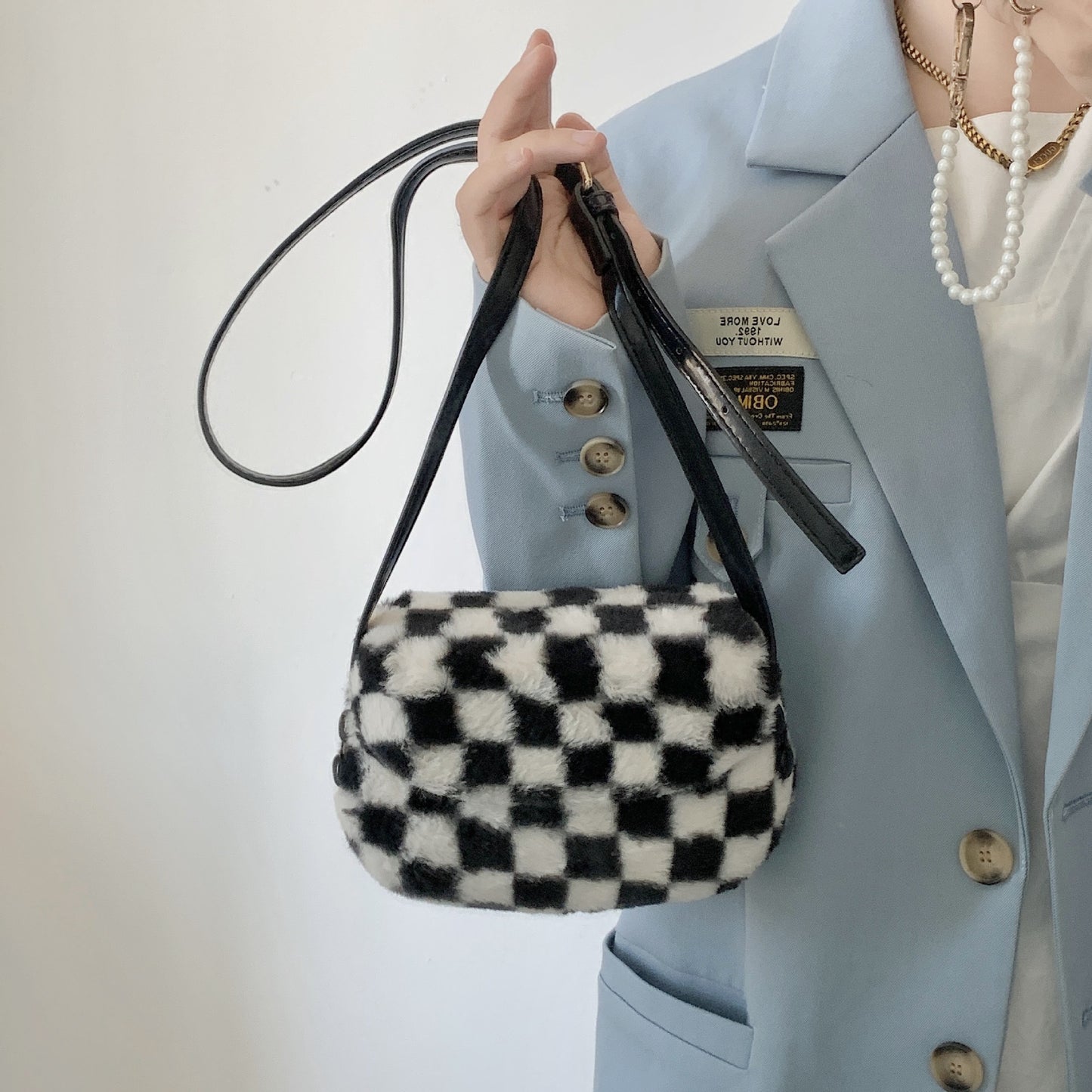 FLOWERSVERSE 2025 Autumn and winter new furry saddle bag crossbody small bag women  Korean retro black and white plaid furry bag