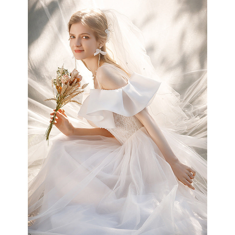 light wedding dress 2025 new bride one-word shoulder suspenders small bow temperament presiding over dress trailing